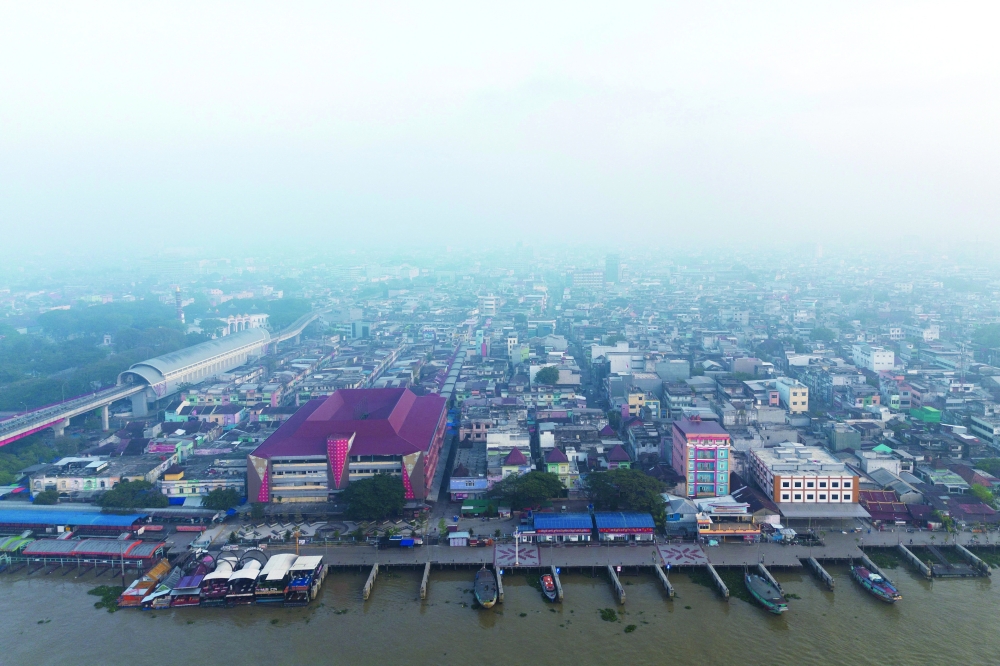 A drone view shows boats docked at the Musi river as smog covers it due to recent wildfires in Palembang, South Sumatra province, Indonesia. — Reuters 