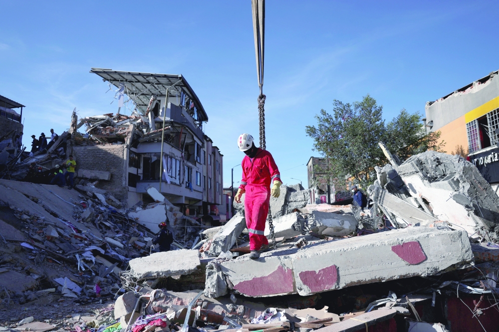 Emergency personnel work at the site of a damaged building following an earthquake, in Pereira, Colombia. — Reuters 