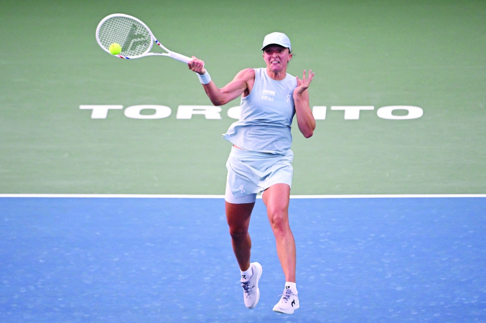 Iga Swiatek (POL) plays a shot against Diana Shnaider during their quarterfinal at Sobeys Stadium. — Imagn Images