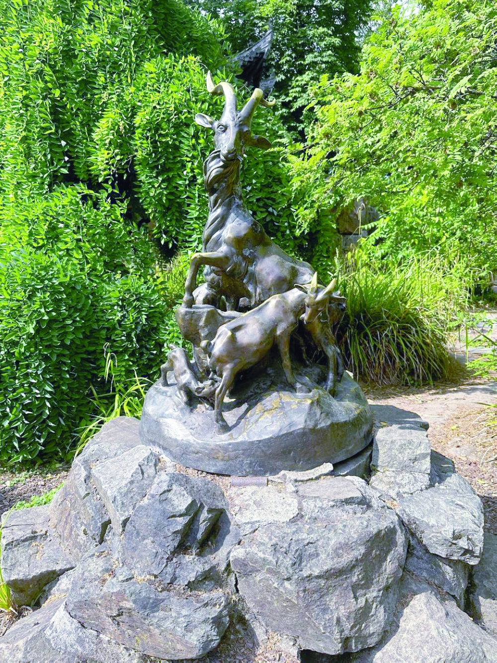 Bronze garden sculpture of a goat family
