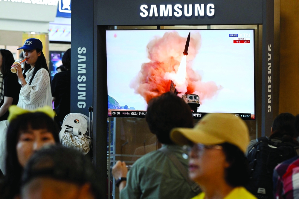 News coverage shows footage of a North Korean missile launch on a screen at Seoul Station in Seoul. - AFP