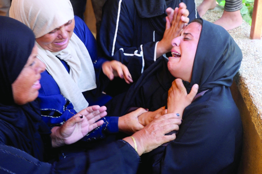 Mourners react at the funeral of a Palestinian man Huthaifa Kawari, who was killed in an Israeli strike, according to medics, at Nasser Hospital in Khan Yunis, in the southern Gaza Strip. - Reuters