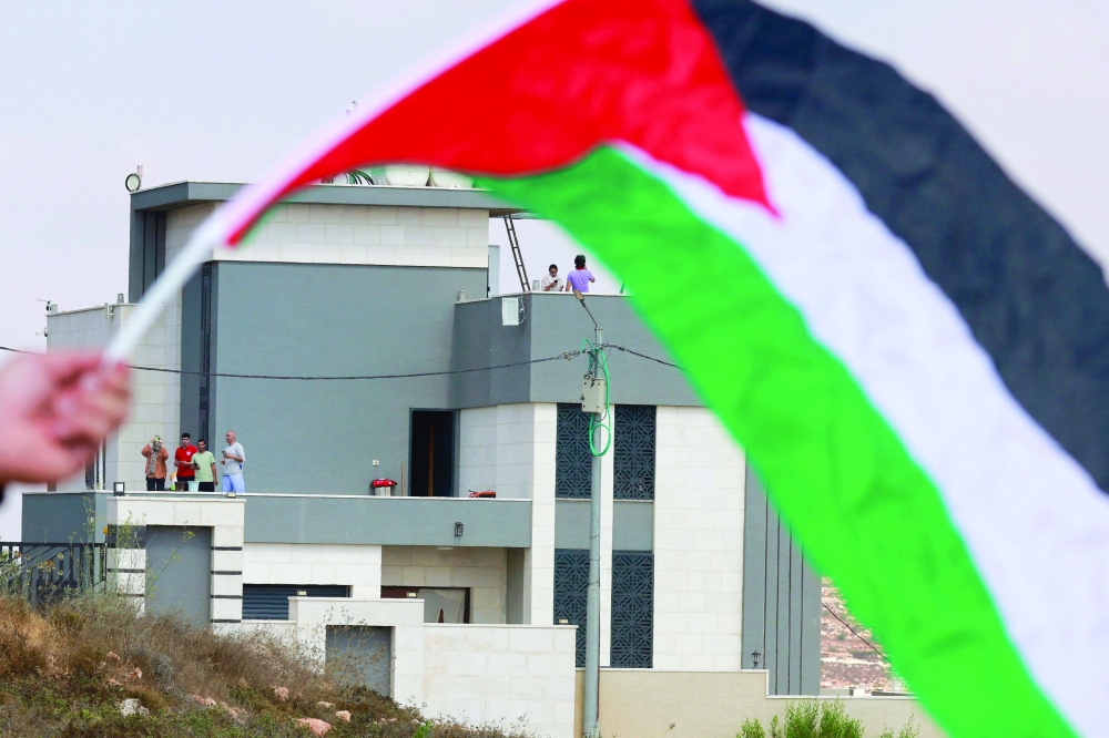 Activists march towards the residents in a besieged Palestinian home in the village of Qusra, south of the city Nablus, in the Israeli-occupied West Bank. 