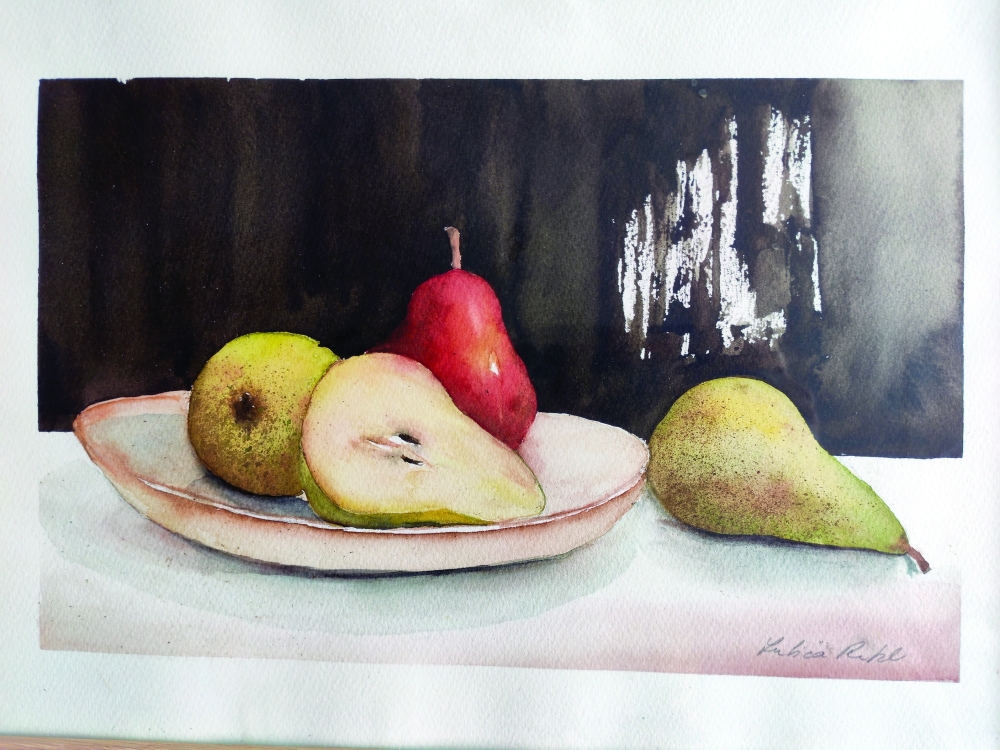 Ripe pears on a simple plate, one sliced open