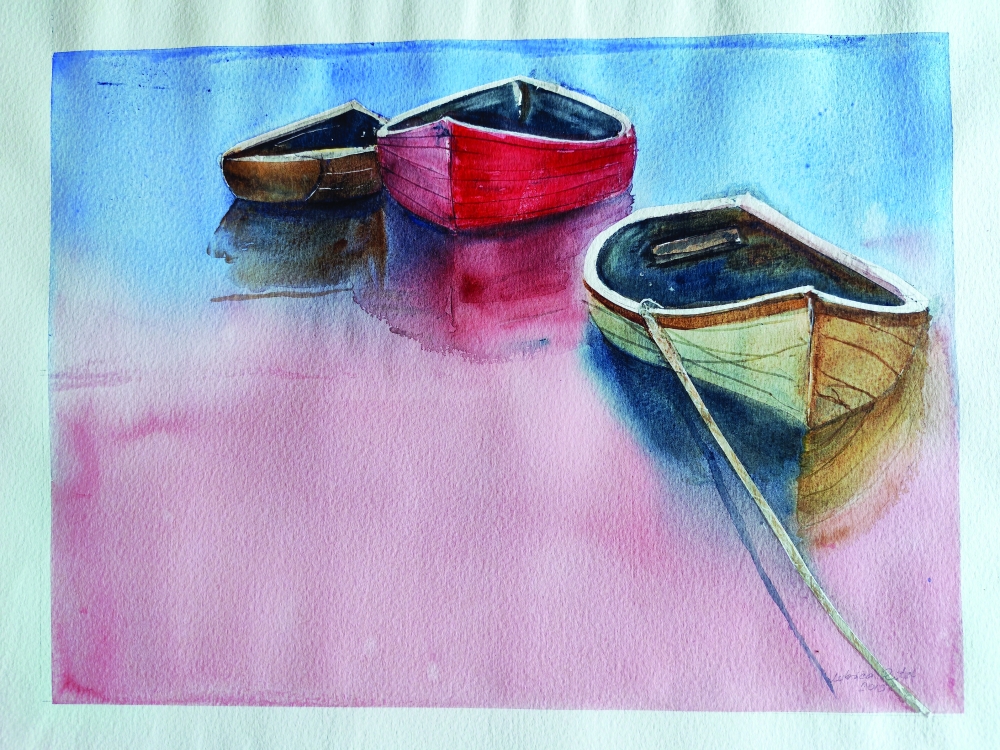 Three boats resting quietly on calm, reflective water
