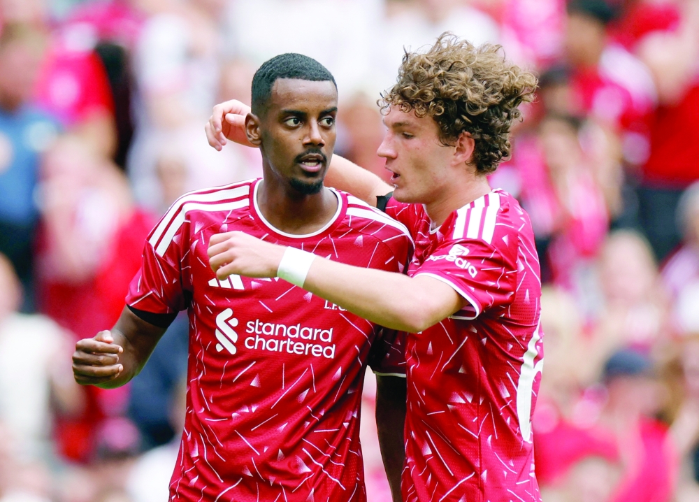 Liverpool's Isak celebrates with Koumas. — Reuters