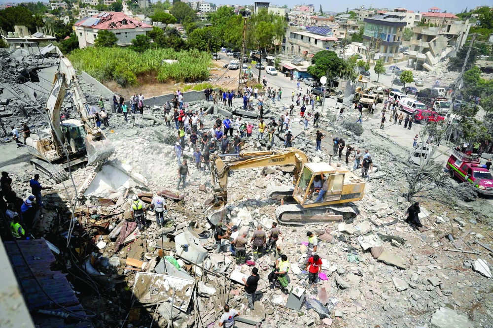 Heavy machinery, first aid responders and residents search the site of an Israeli airstrike that targeted a neighbourhood in the southern Lebanese village of Deir al-Zahrani on August 15, 2026. Lebanon said Israeli strikes on the south killed nine people including three children on August 15, 2026, the deadliest raids since deals in June eased hostilities between Israel and Hezbollah. Israel said it carried out retaliatory strikes against the Iran-backed militant group but Lebanon's prime minister said seven people killed in one of the strikes were not "military targets" and urged Israel to halt an "extremely dangerous" escalation. (Photo by Abbas FAKIH / AFP)

