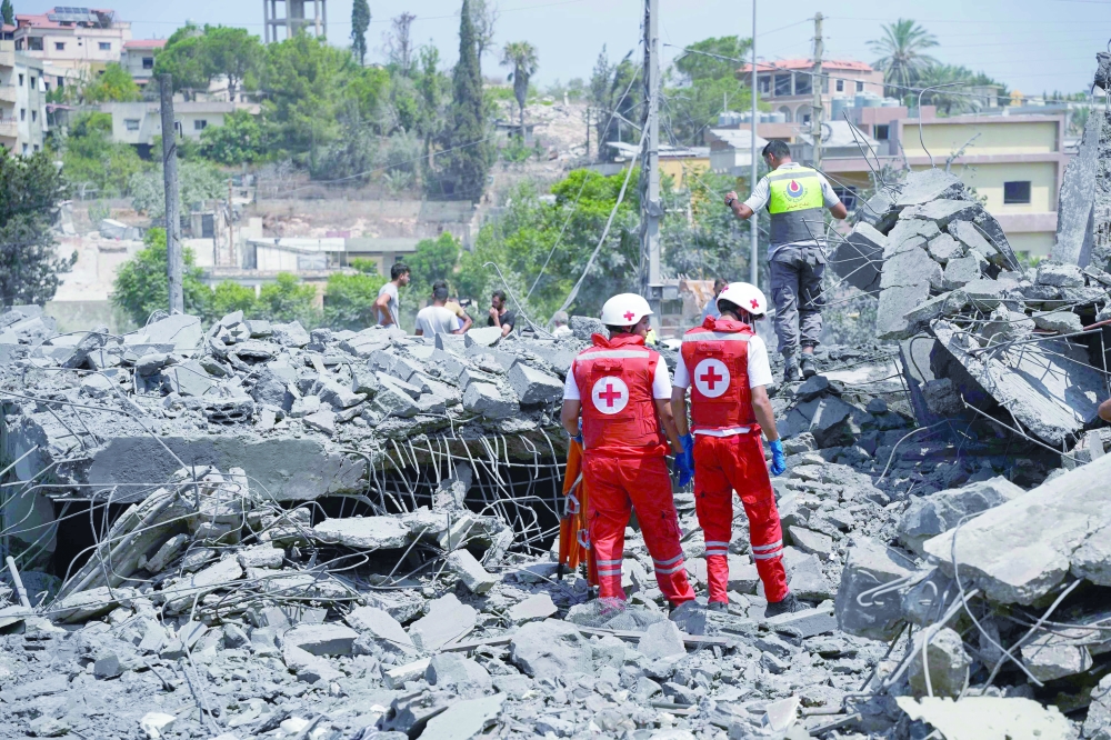 First aid responders and residents rush to the site of an Israeli airstrike in the southern Lebanese village of Deir Al Zahrani. — AFP