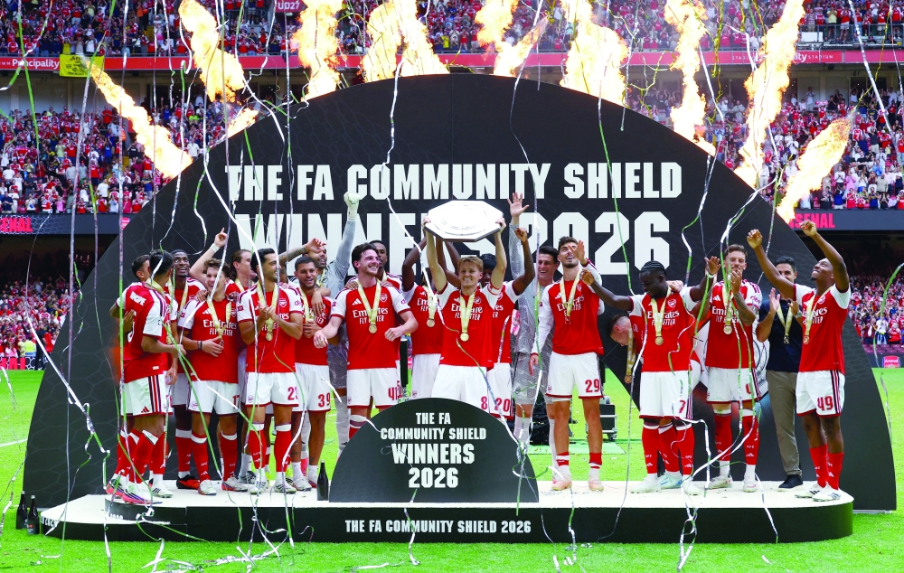 Arsenal's Martin Odegaard lifts the trophy as he celebrates with teammates after winning the FA Community Shield Action. — Reuters