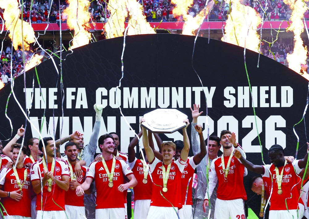 Arsenal's Martin Odegaard lifts the trophy as he celebrates with teammates after winning the FA Community Shield Action. — Reuters