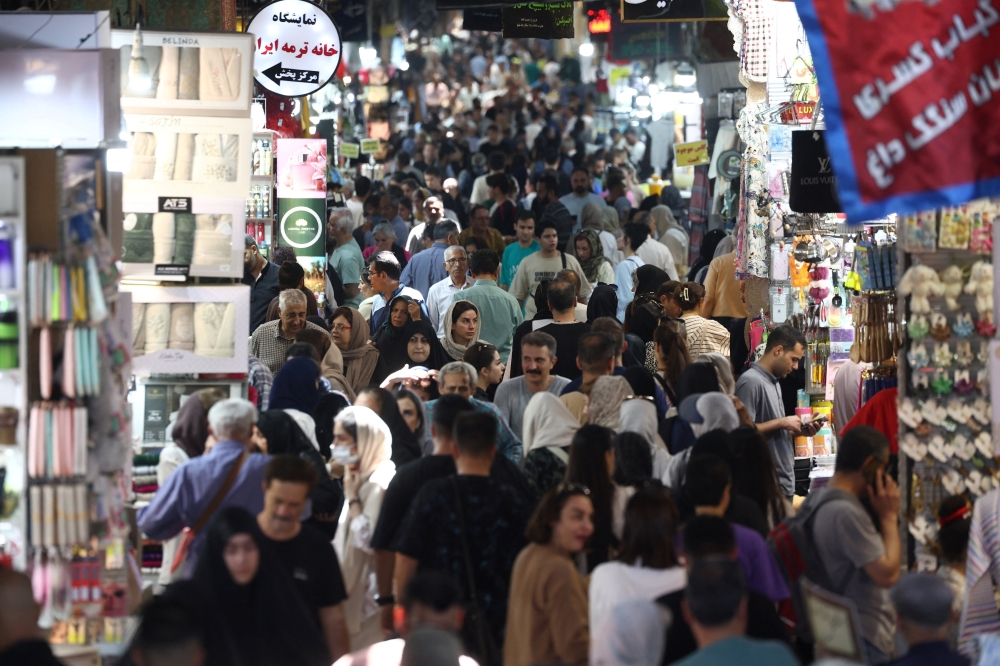 People walk in the Grand Bazaar in Tehran, Iran, August 11, 202