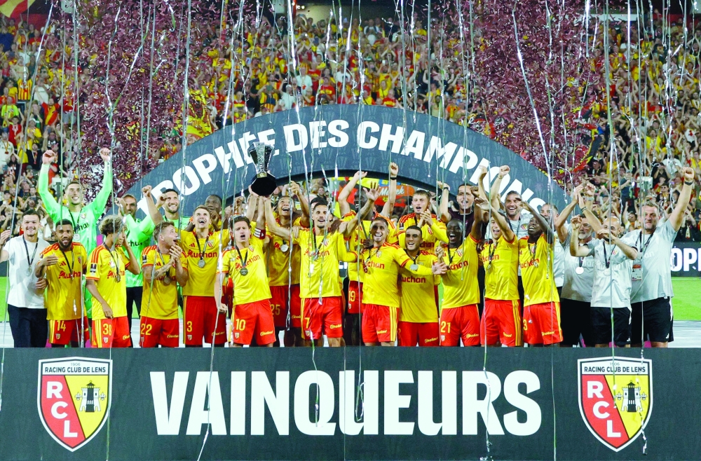 Lens' players celebrate with the championship trophy after winning the French Super Cup (Trophee des Champions) football match between RC Lens and Paris Saint-Germain. — AFP