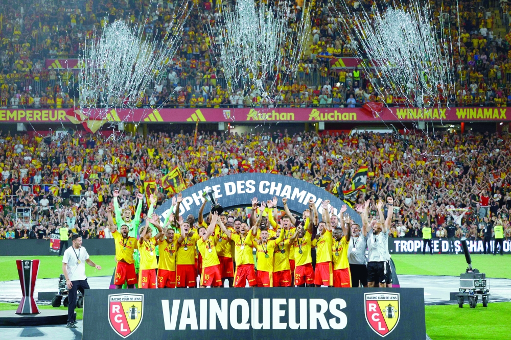 Lens' players celebrate with the championship trophy after winning the French Super Cup (Trophee des Champions) football match between RC Lens and Paris Saint-Germain. — AFP