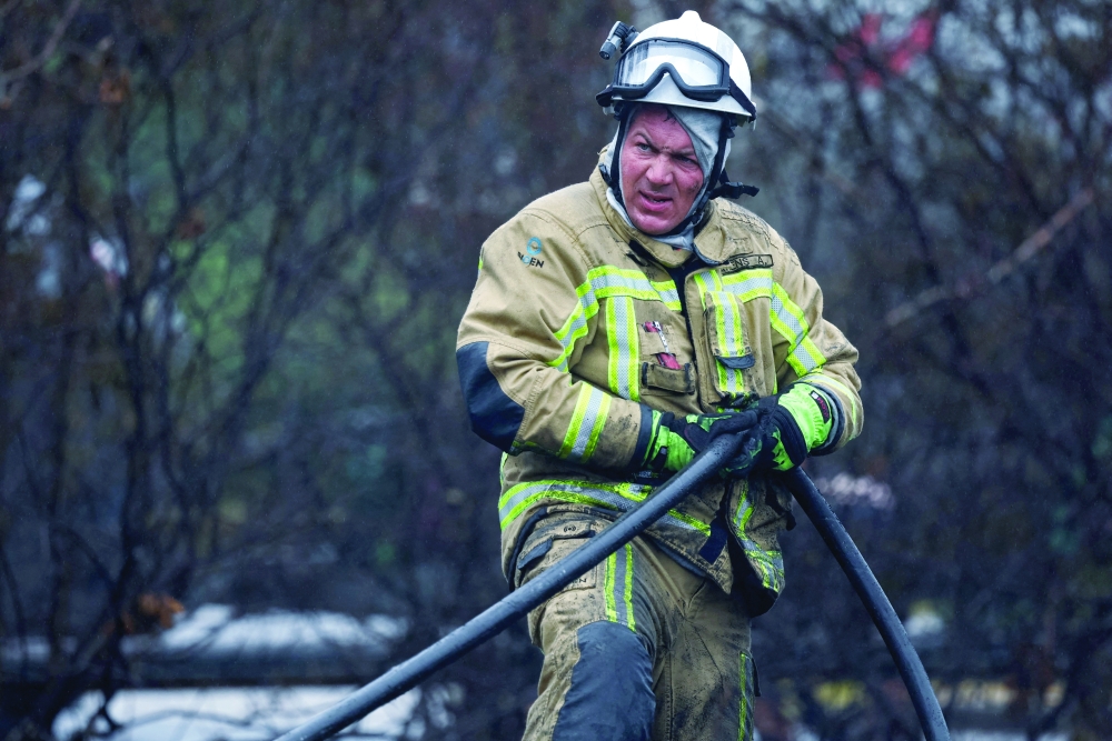 A Belgian firefighter works in a forest affected by a wildfire in Waimes, Belgium. — Reuters 