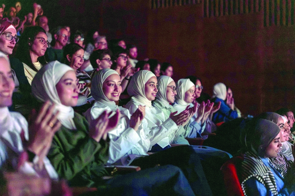 The audience reacts as Palestinian musicians perform on stage during the Jerusalem Festival, held at the Yabous Cultural Centre after a two-year hiatus. — AFP