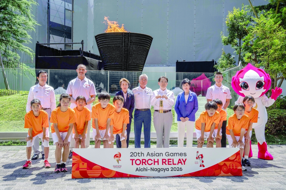 (Back L-R) Mayor of Nagoya Ichiro Hirosawa, former Japanese hammer throw athlete Koji Murofushi, President of the Japan Olympic Committee Seiko Hashimoto, Vice President of the Olympic Council of Asia Tsunekazu Takeda, Governor of Aichi Prefecture Hideaki Omura, Governor of Tokyo Yuriko Koike and Japanese sprinter Yoshihide Kiryu pose during the torch lighting ceremony for the 2026 Asian Games, outside the National Stadium in Tokyo on Tuesday. About 15,000 competitors and officials are expected at the event, which takes place in Nagoya and the wider Aichi area from September 19 to October 4. — AFP
