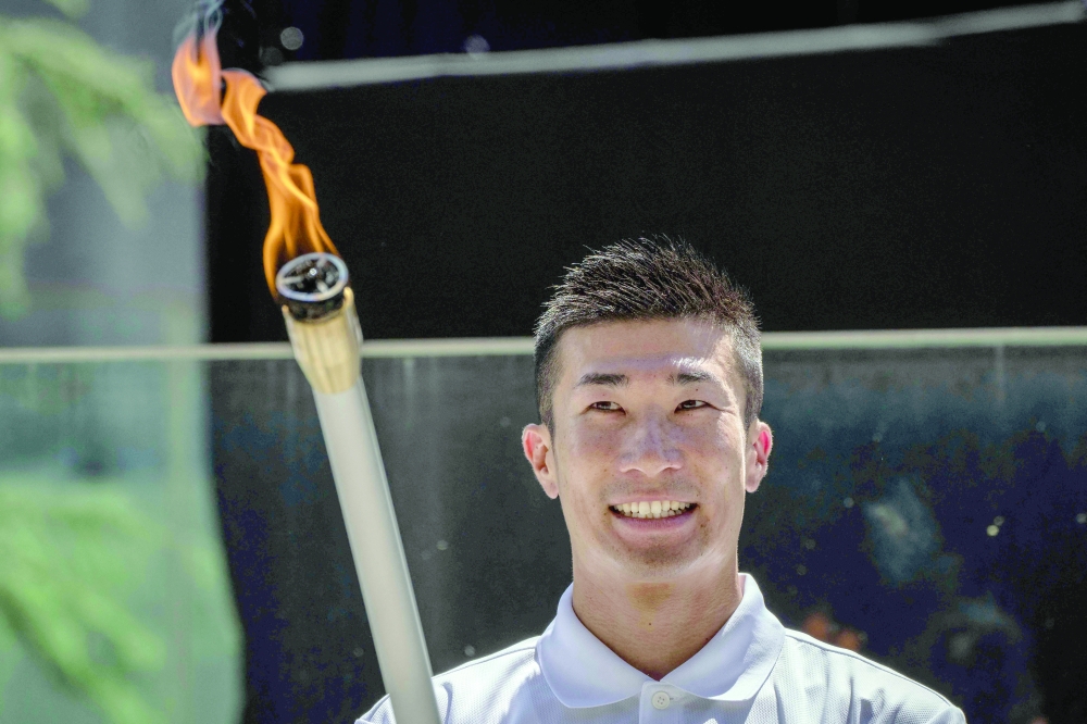 Japanese sprinter Yoshihide Kiryu takes part in the torch lighting ceremony for the 2026 Asian Games, outside the National Stadium in Tokyo on August 18. About 15,000 competitors and officials are expected at the event, which takes place in Nagoya and the wider Aichi area from September 19 to October 4. — AFP

