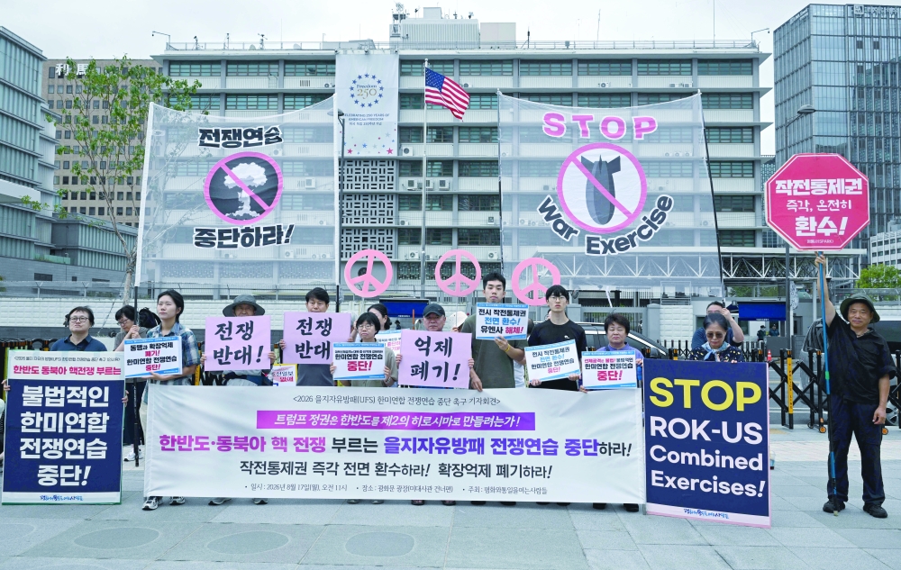South Korean protesters hold placards as they attend a rally to oppose the joint military exercise between South Korea and the US in Seoul. — AFP