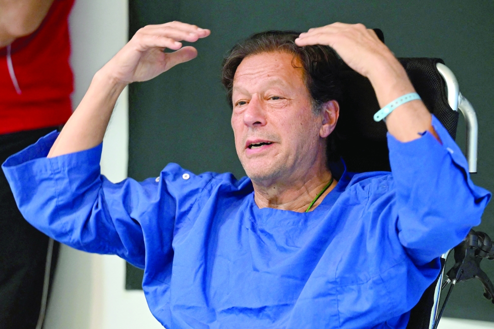 Pakistan's former prime minister Imran Khan addresses media representatives at a hospital in Lahore. — AFP file photo