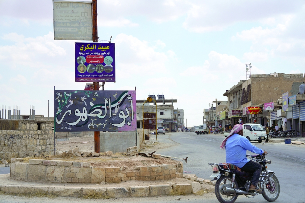 A man rides a motorbike in the town of Abu Al Duhur, Syria. — Reuters