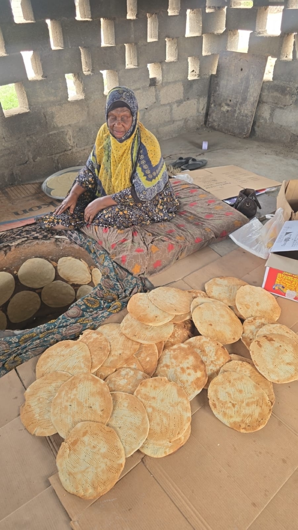 Taliiah bint Naseeb bin Farag, known as Umm Abdulrahman, prepares traditional Qalib bread in the Wilayat of Taqah.