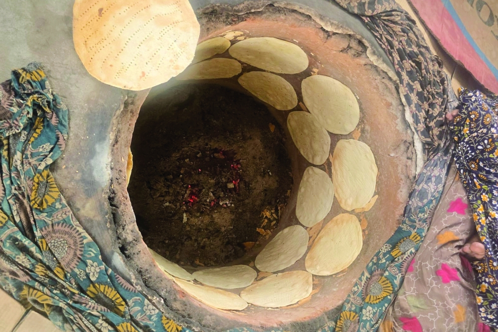 Qalib bread is baked in a traditional tanoor until it turns reddish-brown.