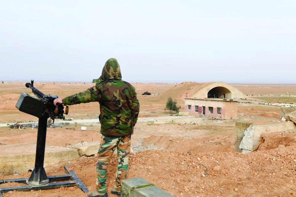 A member of Syrian government forces stands guard at the Abu Al Duhur base in Idlib province. — AFP file photo