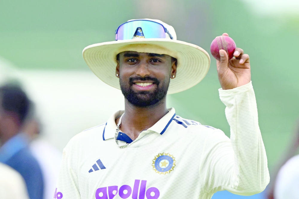 India's Manav Suthar shows the ball after taking a six-wicket haul as he celebrates his team's win at the end of the fifth day of the first Test cricket match between Sri Lanka and India at the Galle International Stadium in Galle on August 19, 2026.  (Photo by Ishara S. KODIKARA / AFP)
