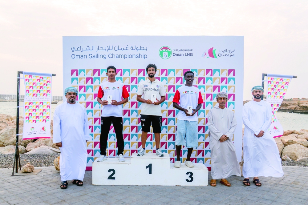 The top three finishers in the ILCA 6 class.
