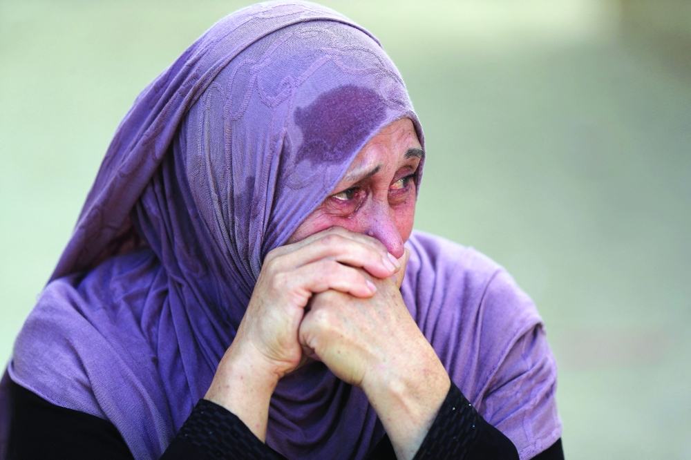A woman reacts during the funeral of Palestinians killed in an Israeli strike on a cafe in Gaza City on Wednesday. — Reuters