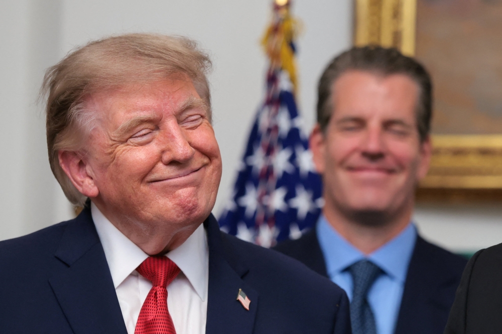 U.S. President Donald Trump reacts during a press conference with cryptocurrency executives in the Roosevelt Room at the White House in Washington, D.C.