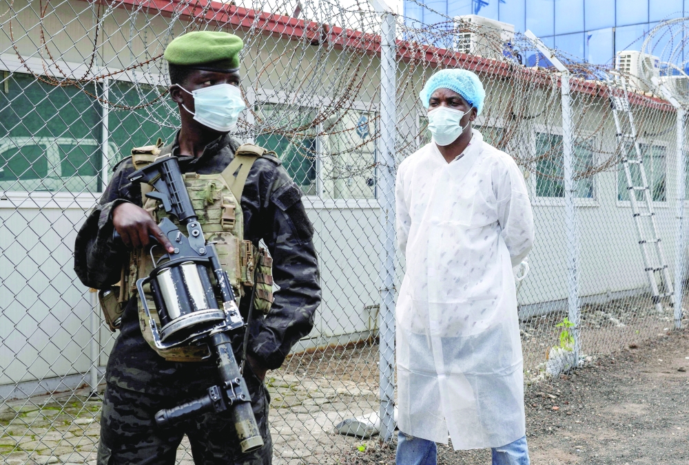 A member of the M23 rebel group stands guard as provincial authorities visit the Rodolphe Merieux Laboratory, where samples from suspected Ebola cases are tested, in Goma, North Kivu province of Congo.- Reuters File