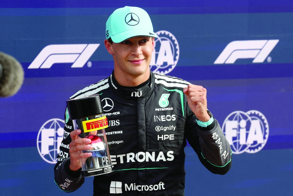 Mercedes' George Russell celebrates after winning pole position for the sprint race. — Reuters