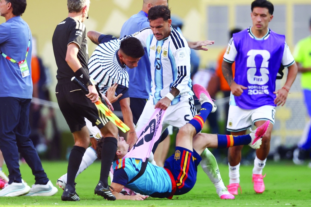 Argentina's #05 Leandro Paredes (top) clashes with Spain's #09 Gavi during the 2026 World Cup final match between Spain and Argentina at the New York/New Jersey Stadium in East Rutherford on July 19. — AFP