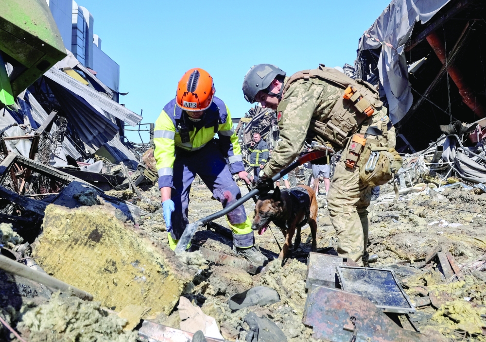 Rescuers with a dog work at the site of a shopping centre destroyed by a Russian drone attack in the city of Kryvyi Rih, Dnipropetrovsk region. — Reuters