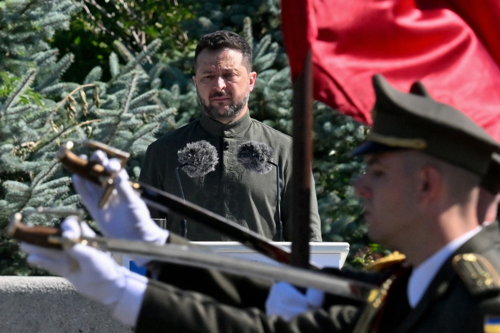 Ukraine's President Volodymyr Zelensky stands in front of the Ukrainian guard of honour parade as he attends a ceremony marking the National Flag Day of Ukraine in Kyiv. — AFP