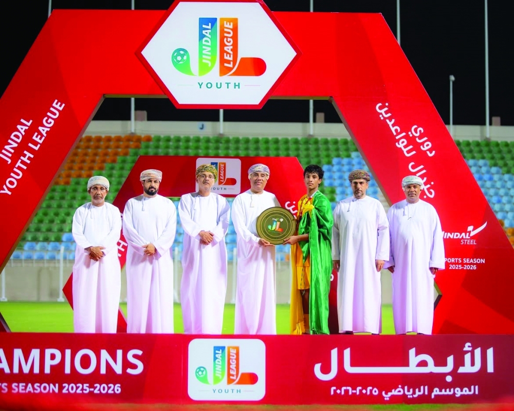 Dr Faisal bin Abdullah al Farsi presents the Jindal Youth League shield to Seeb captain Muadh al Mahrami.