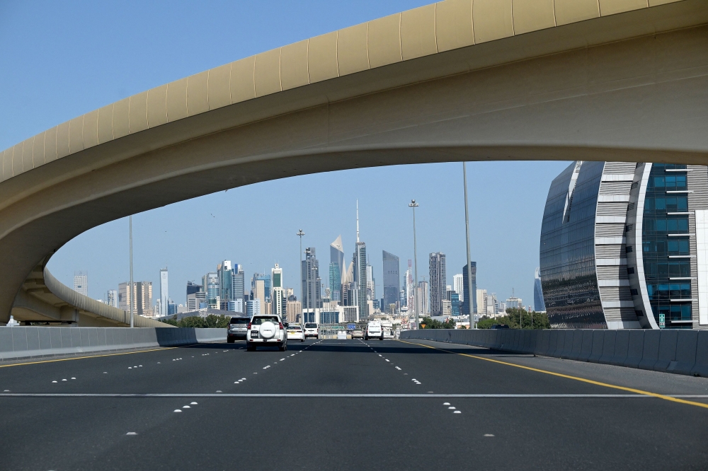  Vehicles drive along the highway leading to and from Kuwait City