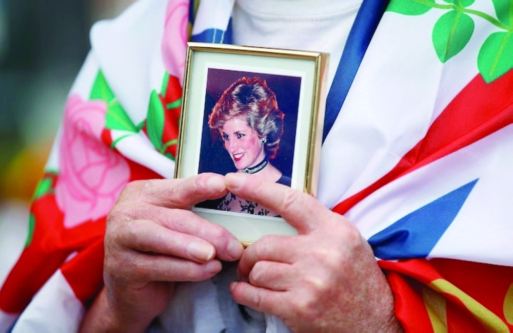 A royal fan holds a picture of Princess Diana as he pays tribute to her, on the 25th anniversary of her death. — Reuters
