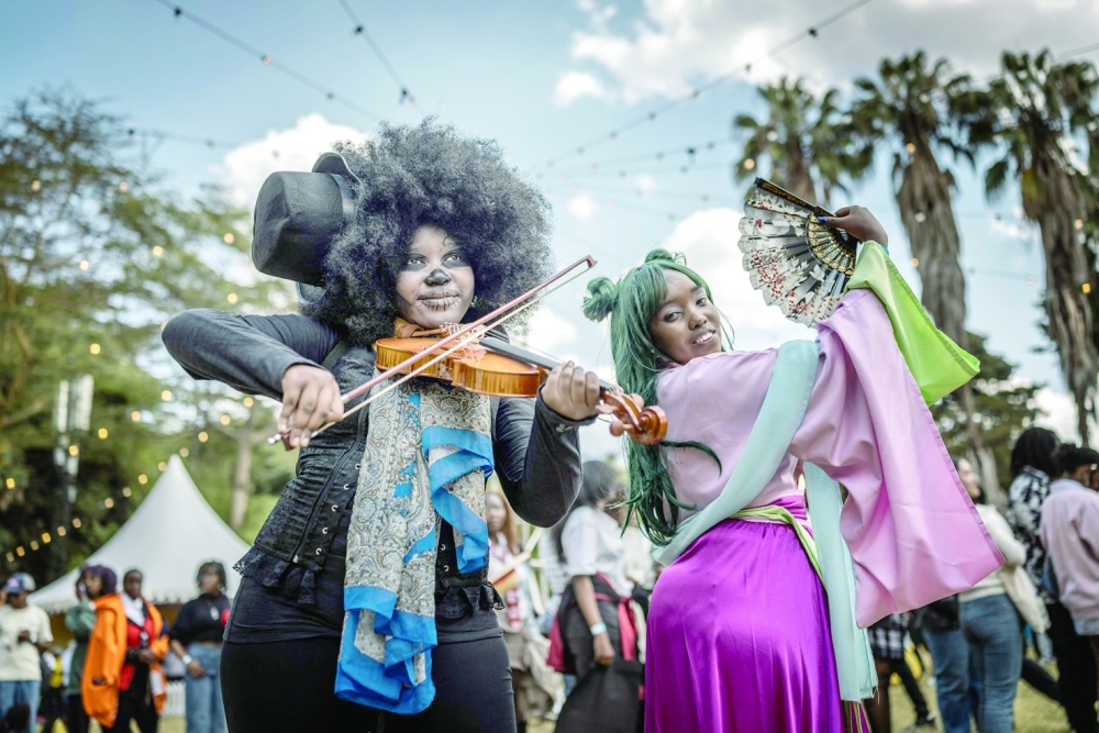 Cosplayers and Japanese culture fans pose for social media content during the Otamatsuri convention in Nairobi. — AFP