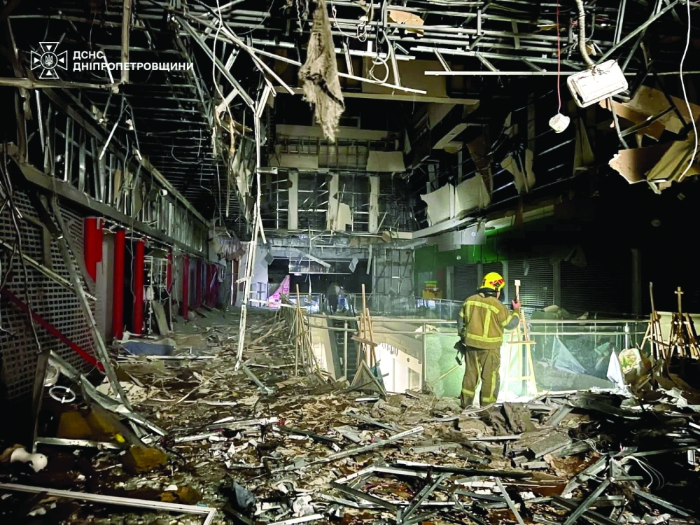 A rescuer works at the site of a shopping mall hit by a Russian drone attack in Dnipro, Ukraine. — Reuters