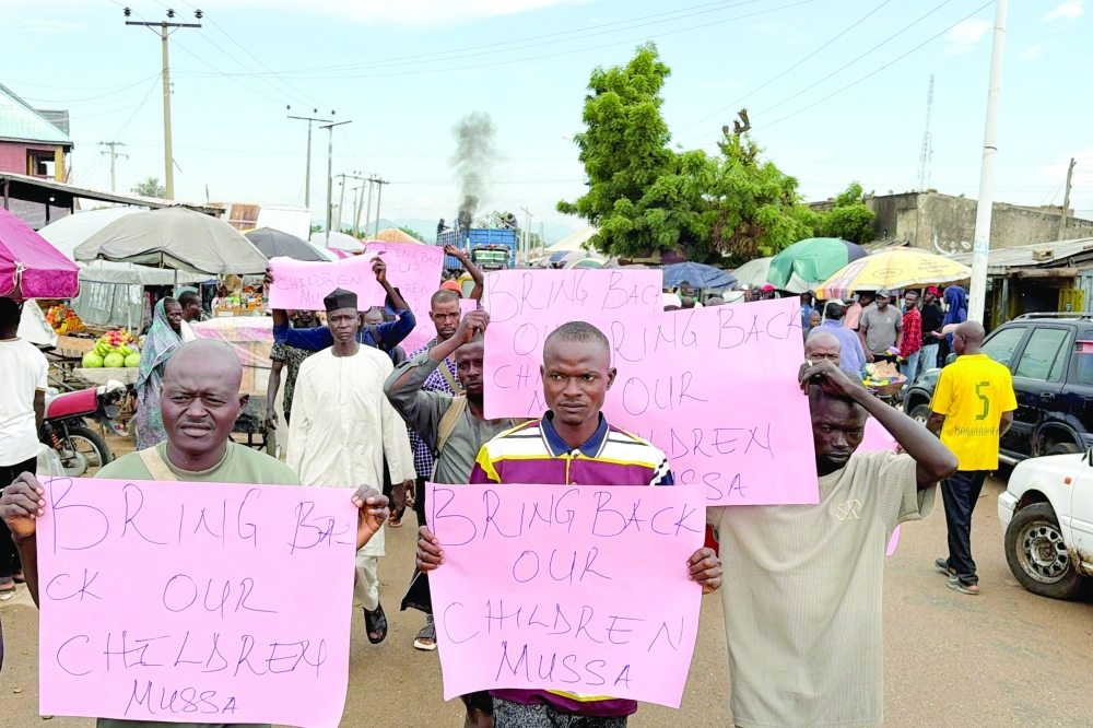 Parents of abducted students hold placards during a protest calling for their release in Askira-Uba, Borno State, Nigeria. — Reuters