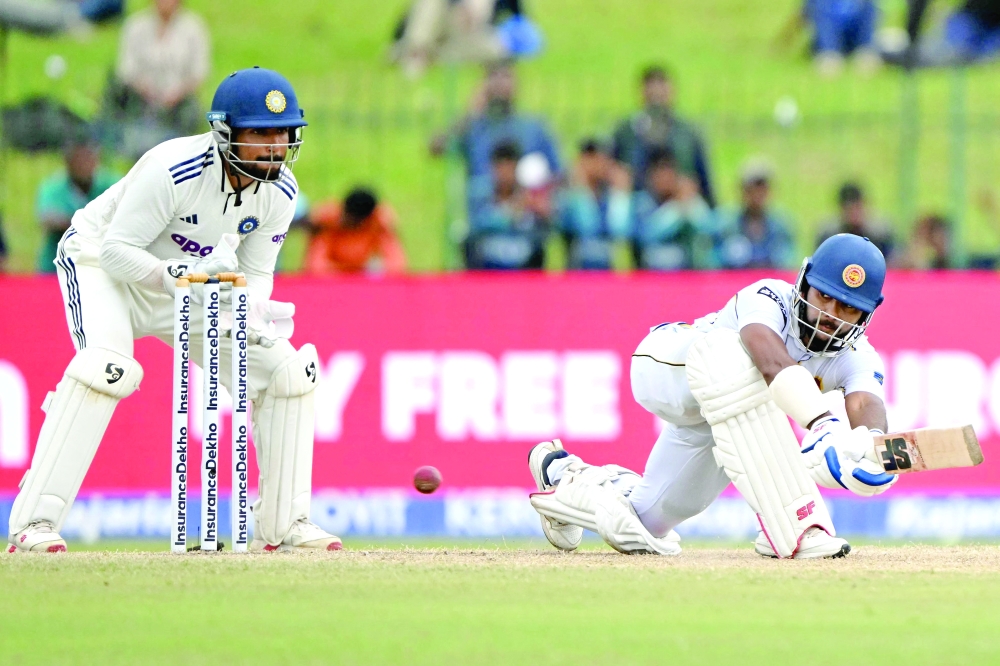 Sri Lanka's Sonal Dinusha plays a shot as India's wicketkeeper Dhruv Jurel gestures during the third day of the second Test cricket match between Sri Lanka and India at the Sinhalese Sports Club Ground in Colombo. — AFP