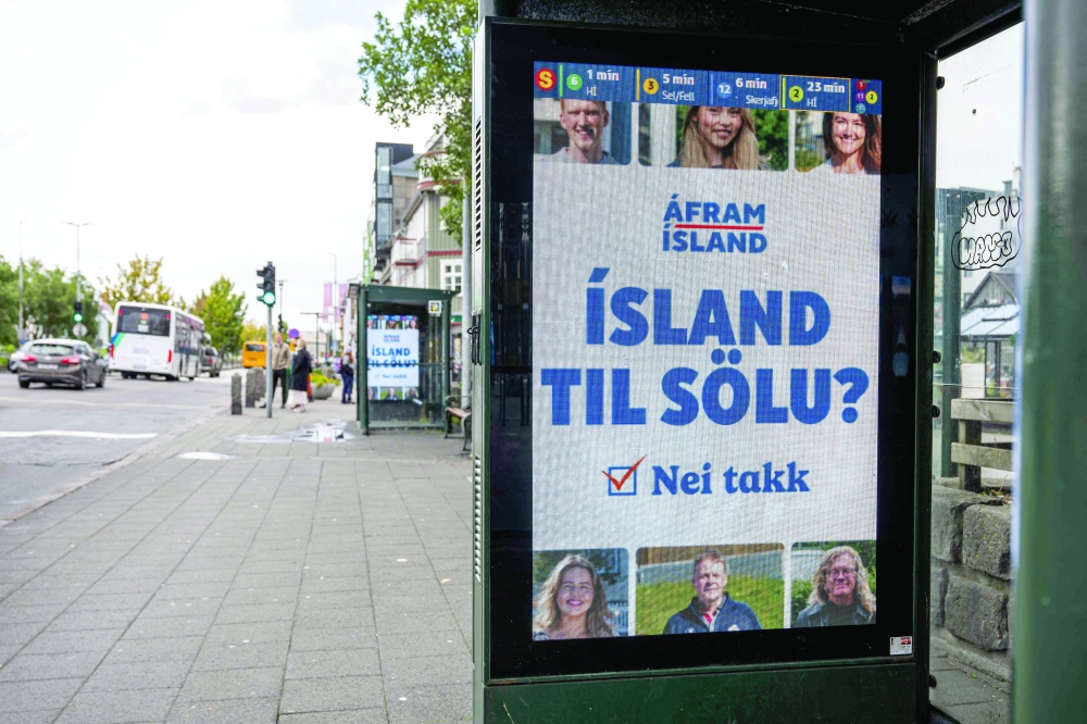This image shows a campaign advertisement reading "Iceland for sale? No thanks” displayed at a bus stop in central Reykjavik, Iceland. — AFP
