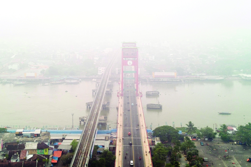 A drone view shows the Ampera Bridge shrouded in haze from wildfires in Palembang, Indonesia. — Reuters