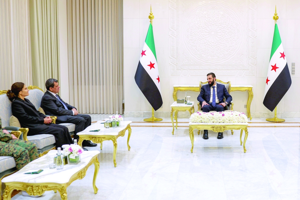 Syria's president Ahmed al-Sharaa (R) attends a meeting with Mazloum Abdi (2nd-L), the leader of the Kurdish-led Syrian Democratic Forces (SDF), at the People's Palace in Damascus. — AFP