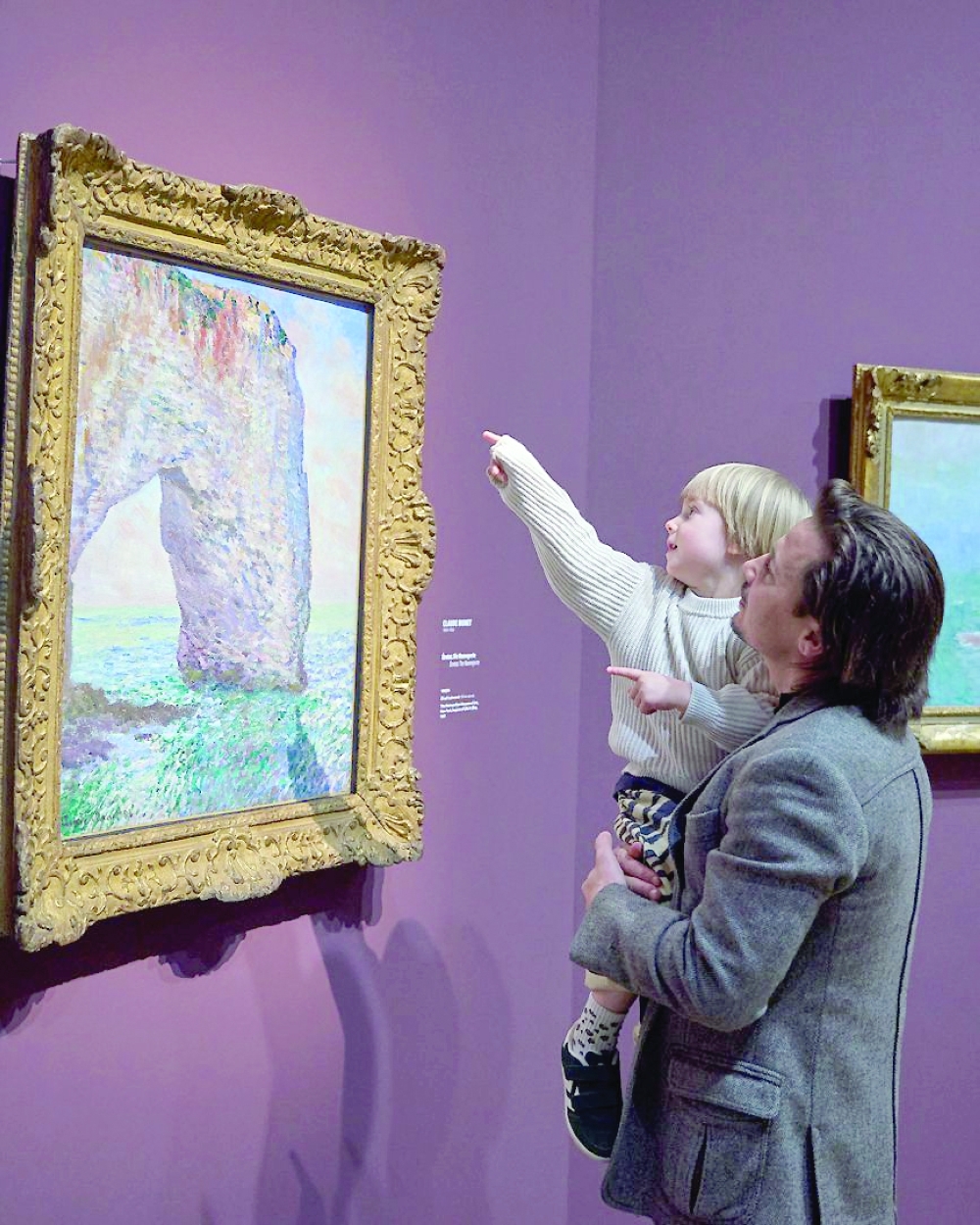 A young visitor points out Monet’s iconic Étretat cliffs at the Städel Museum’s Normandy exhibition.