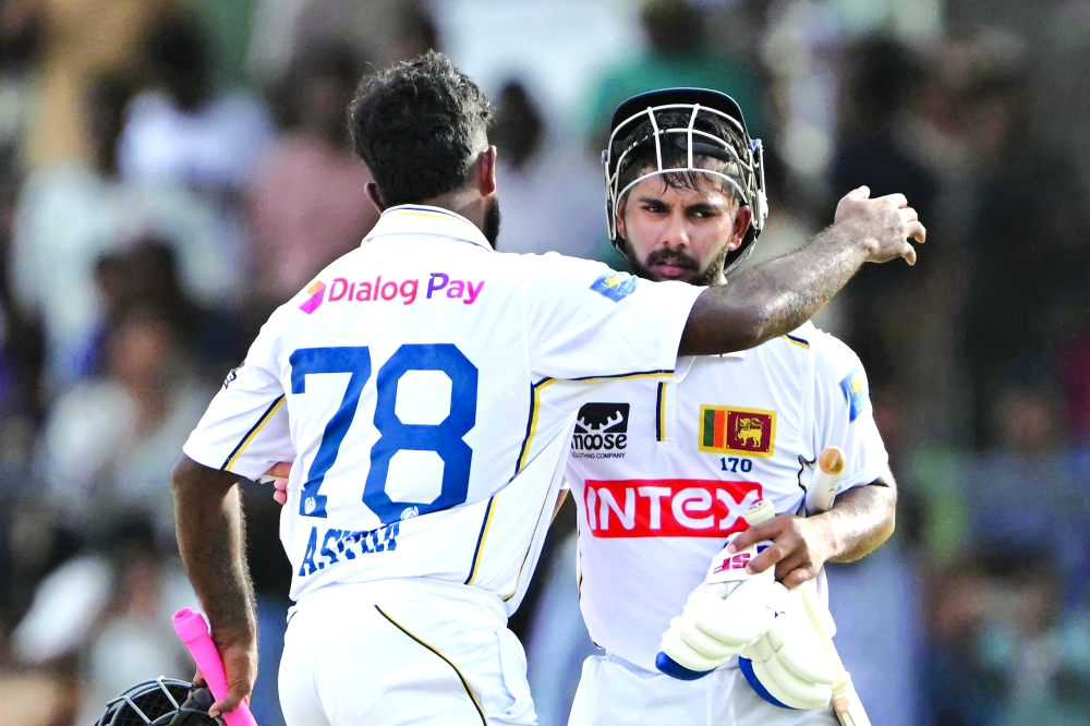 Sri Lanka's Asitha Fernando embraces Sonal Dinusha in the end of the fifth day of the second Test cricket match between Sri Lanka and India at the Sinhalese Sports Club Ground in Colombo on August 27, 2026.  (Photo by Ishara S. KODIKARA / AFP)
