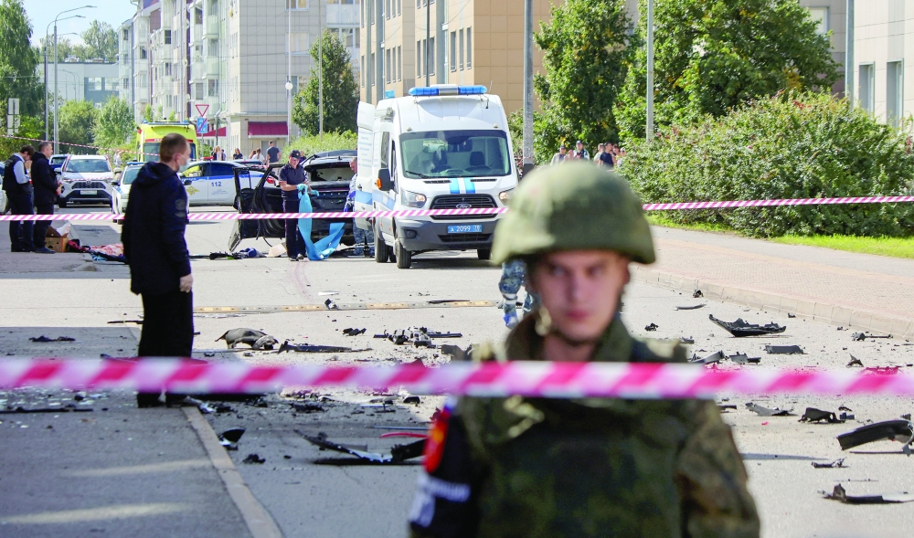 Investigators work at the site of a car explosion that killed a Russian military serviceman, in St Petersburg, Russia. - Reuters