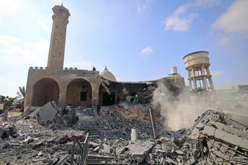 Volunteers carry out conservation work as part of an initiative to protect the historical features of the damaged Abu Salim mosque that was recently hit by an Israeli strike on Thursday. - AFP